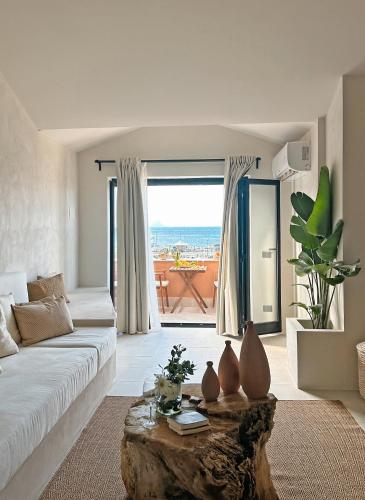 a living room with a white couch and a table at Almarìa - Le case del Castello - San Nicola L'Arena - Trabia in Trabia