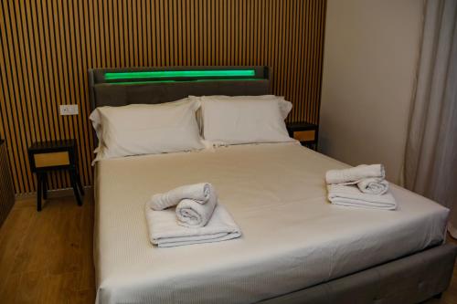 a bedroom with a bed with towels on it at Futura Guest House in Bari