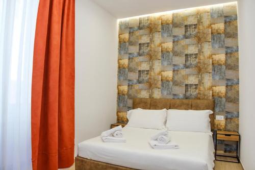 a bedroom with a bed and a orange curtain at Futura Guest House in Bari