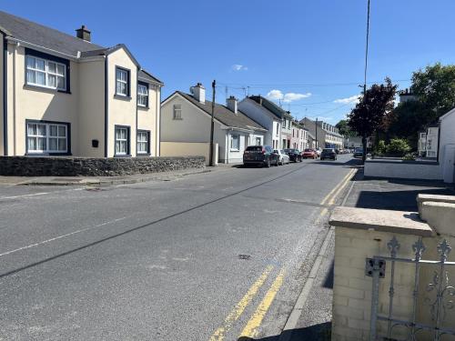 an empty street in a residential neighborhood with houses at Erin House - Oughterard Central in Oughterard
