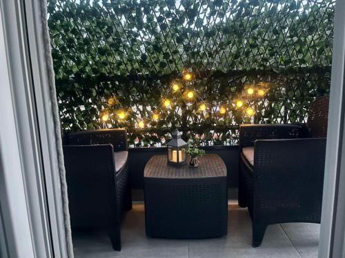 a restaurant with a table and chairs and lights at Apartman 3N in Veliko Gradište