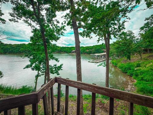 a view of a river from a wooden deck at Lakefront Treetop Village 2bd3badeckpool-6pp in Four Seasons