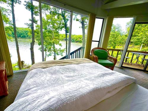 a bedroom with a bed and a view of a river at Lakefront Treetop Village 2bd3badeckpool-6pp in Four Seasons