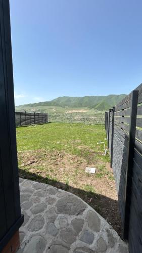 a view of a fence and a field at Shahdag Berghoff House in Qusar