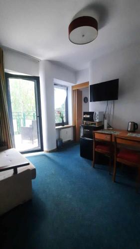 a living room with a couch and a table at Apartament w Sosnowym SPA in Serock