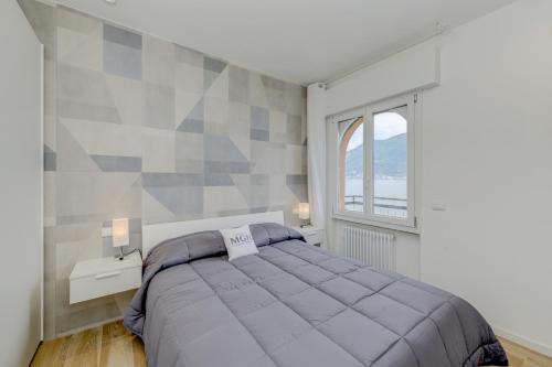 Katil atau katil-katil dalam bilik di MGH- Ora del Garda Lakeview Apartment