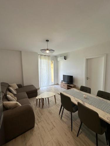 a living room with a couch and a table at Casa Del Mar 2 in Shëngjin