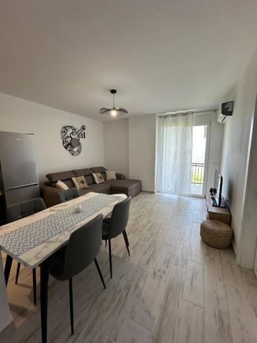 a living room with a table and a couch at Casa Del Mar 2 in Shëngjin