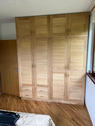 a large wooden cabinet in a room with a bed at Kuca za odmor Agro-Mobil doo Guca in Guča