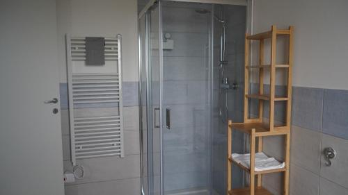 a shower with a glass shower stall in a bathroom at Casa Flory Anna in San Lorenzo