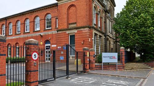 a brick building with a gate in front of it at Queen's Hospital Close near Birmingham City Centre in Birmingham