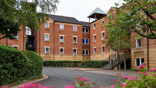 a large brick building with stairs in front of it at Queen's Hospital Close near Birmingham City Centre in Birmingham