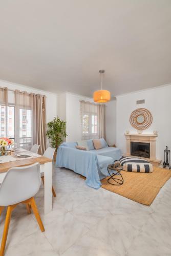 a living room with a bed and a fireplace at Breeze Beach House in Setúbal