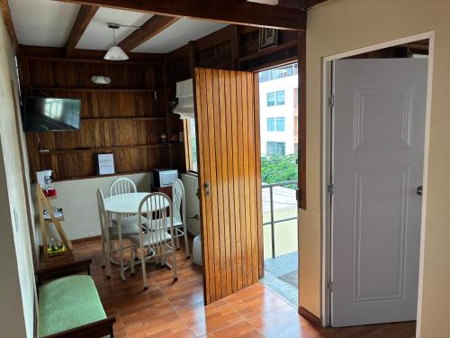 a kitchen and dining room with a table and a window at Apartamento en zona monumental de Barranco in Lima