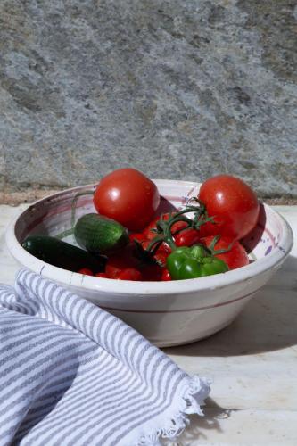 a bowl of vegetables sitting on a table at Under The Linden Tree Tinos in Xinára