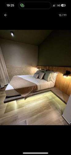 a bedroom with a large bed with lights on it at Casa Cedro in Espera Feliz
