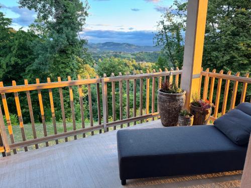 a couch sitting on a porch with a view at Das Gretlnest - Premium Naturrefugium in Gamlitz