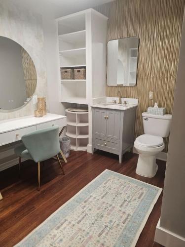 a bathroom with a toilet and a sink and a mirror at The Chelsea in Dayton