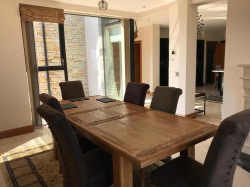 a wooden table and chairs in a room at Serene Luxurious Haven with Sea Views Letterkenny Rooms in Letterkenny
