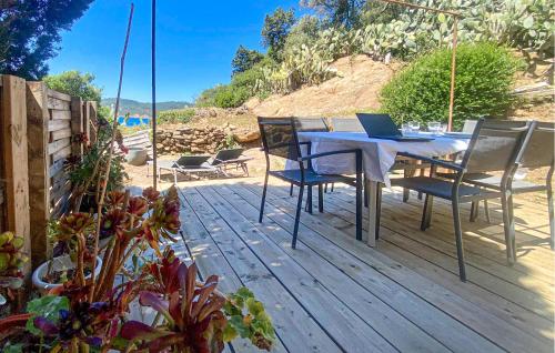a wooden deck with a table with a laptop on it at Stunning Home In Ile Du Levant - Hyères With Wifi in Heliopolis
