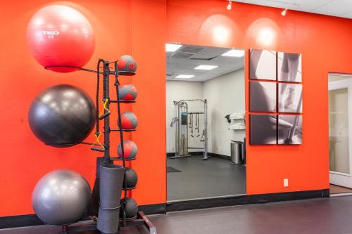 a gym with orange walls and a mirror and balls at Thousand Hills Resort Hotel in Branson