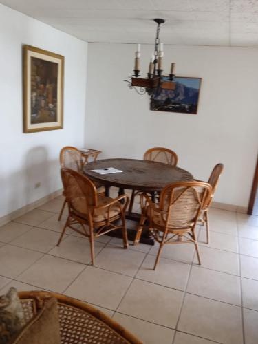 a dining room with a table and chairs at Villa Della Pietra in Chaclacayo