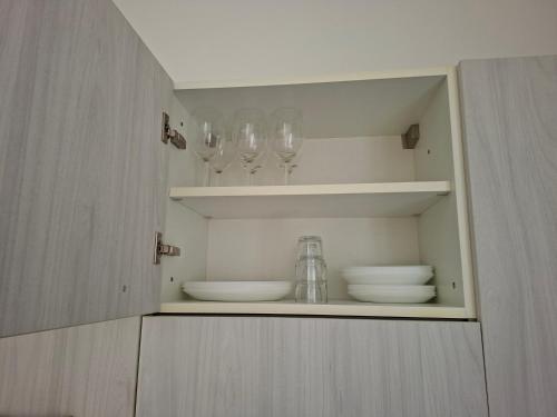 a cupboard with plates and bowls and lights on it at Olly Guest House a Recco - Golfo Paradiso in Recco