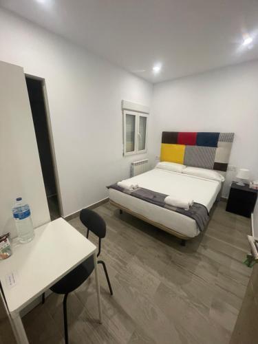 a bedroom with a bed and a table and chairs at Habitación turística en Irún in Irún