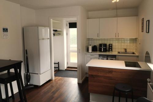 a kitchen with a white refrigerator and a counter at H&M Homes Apartments in Aarhus