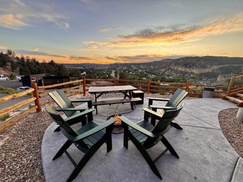a patio with a table and chairs and a fire pit at Yurt Overlook #7 with AC and Private Bath 2 Kings in Orderville