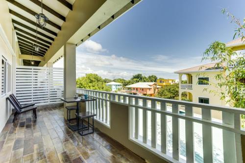 a balcony with a table and chairs and a view at Louis' Apartments in Placencia Village
