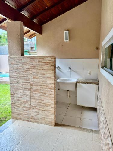 a bathroom with a toilet and a sink at Casa lazer Atafona in São João da Barra