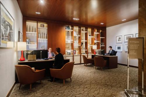 a lobby with two people sitting at desks in a store at InterContinental New York Times Square by IHG in New York