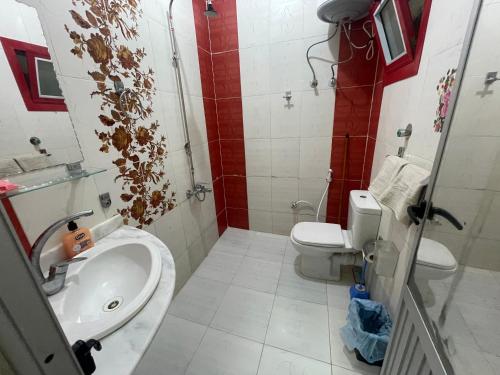 a bathroom with a sink and a toilet at Marvel apartment in Quseir