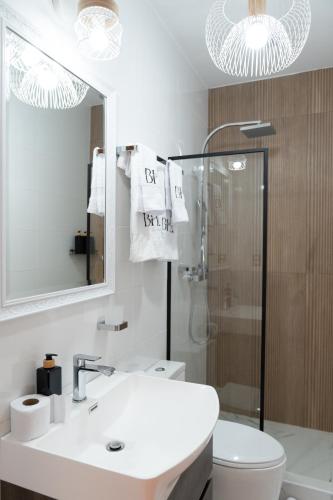 a bathroom with a sink and a toilet and a mirror at Bosco Hotel Boutique in Cusco