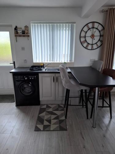 a kitchen with a table and a sink and a stove at Mourne Mountains holiday home in Newcastle