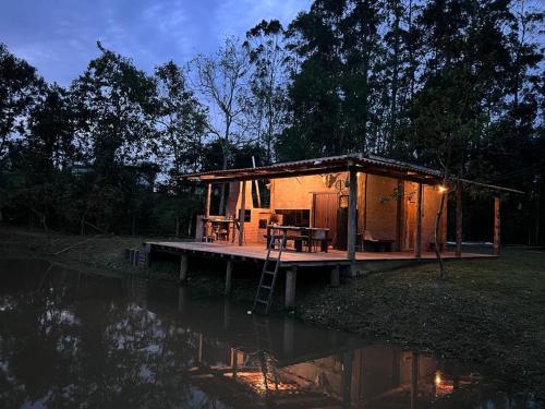 a cabin on a dock next to a body of water at Cabana Maktub in Nova Veneza