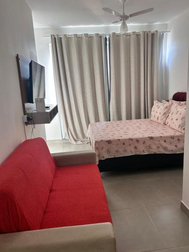 a bedroom with two beds and a red rug at Apê Praia do Forte in Cabo Frio