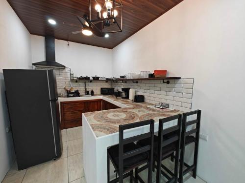 a kitchen with a large island in the middle of it at AJ House & Suites in Uvita