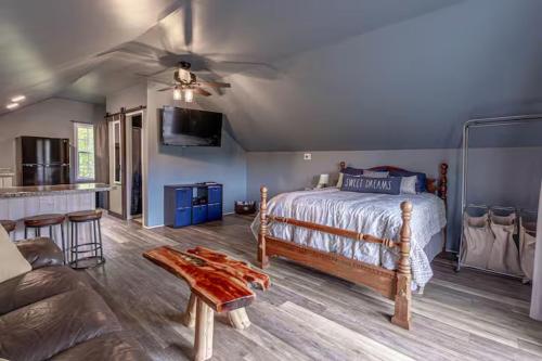 a bedroom with a bed and a living room with a couch at Over Garage Apartment Studio in Lincolnton