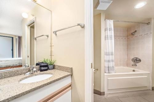 a bathroom with a sink and a bath tub at 1BR Condo with Ski Access Pool, Hot Tub, Gym & Sauna Free Bus in Whistler