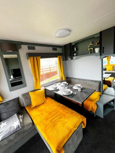 a living room with a dining table in an rv at Caravan Nr 51 Only for Family Holiday in Longmanhill