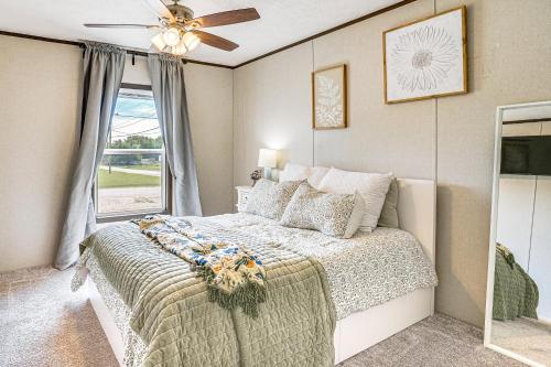 a bedroom with a bed and a ceiling fan at 12 Mi to Possum Kingdom Lake Graford Getaway! in Graford