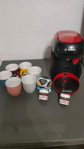 a counter top with bowls and a coffee maker at Studio - Les Capucins in Riom
