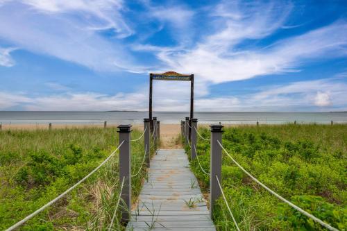 a boardwalk to the beach with a sign on it at Beachfront Unit 17 | Right on Old Orchard Beach! in Old Orchard Beach