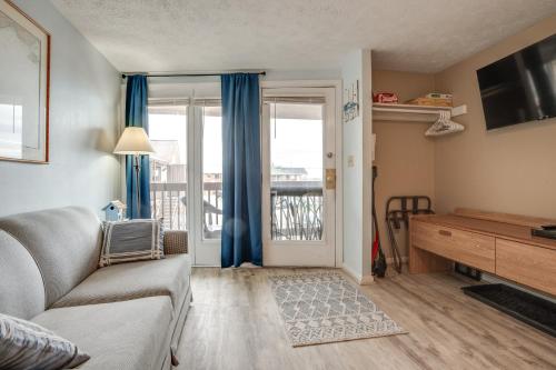 a living room with a couch and a sliding glass door at Beachfront Unit 17 | Right on Old Orchard Beach! in Old Orchard Beach