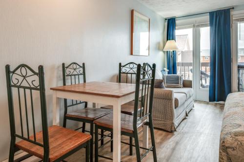 a dining room table and chairs in a living room at Beachfront Unit 17 | Right on Old Orchard Beach! in Old Orchard Beach