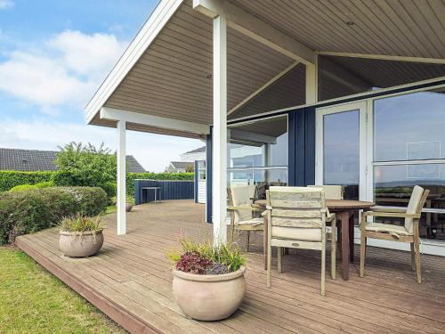 a deck with a table and chairs on a house at 6 person holiday home in Karrebæksminde-By Traum in Karrebæksminde