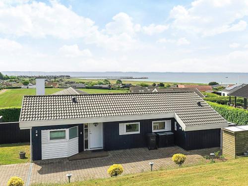 a small house with a view of the ocean at 6 person holiday home in Karrebæksminde-By Traum in Karrebæksminde