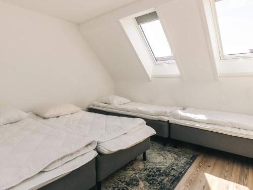 two beds in a room with two windows at Apartment Borre VIII in Borre